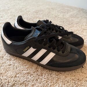 Adidas Samba black with white stripes with no signs of wear and tear.